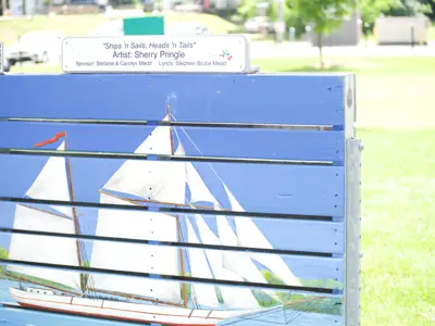 A painting in a park of a sailboat