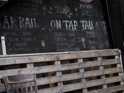 A chalkboard drink menu in a bar 