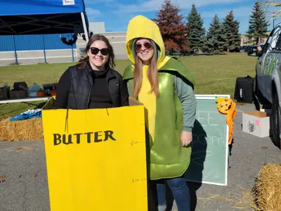 Two people posed for a picture at Trunk or Treating 