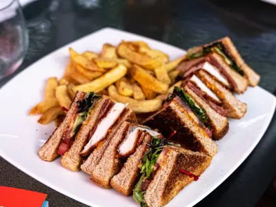 A plate of sandwiches and fries